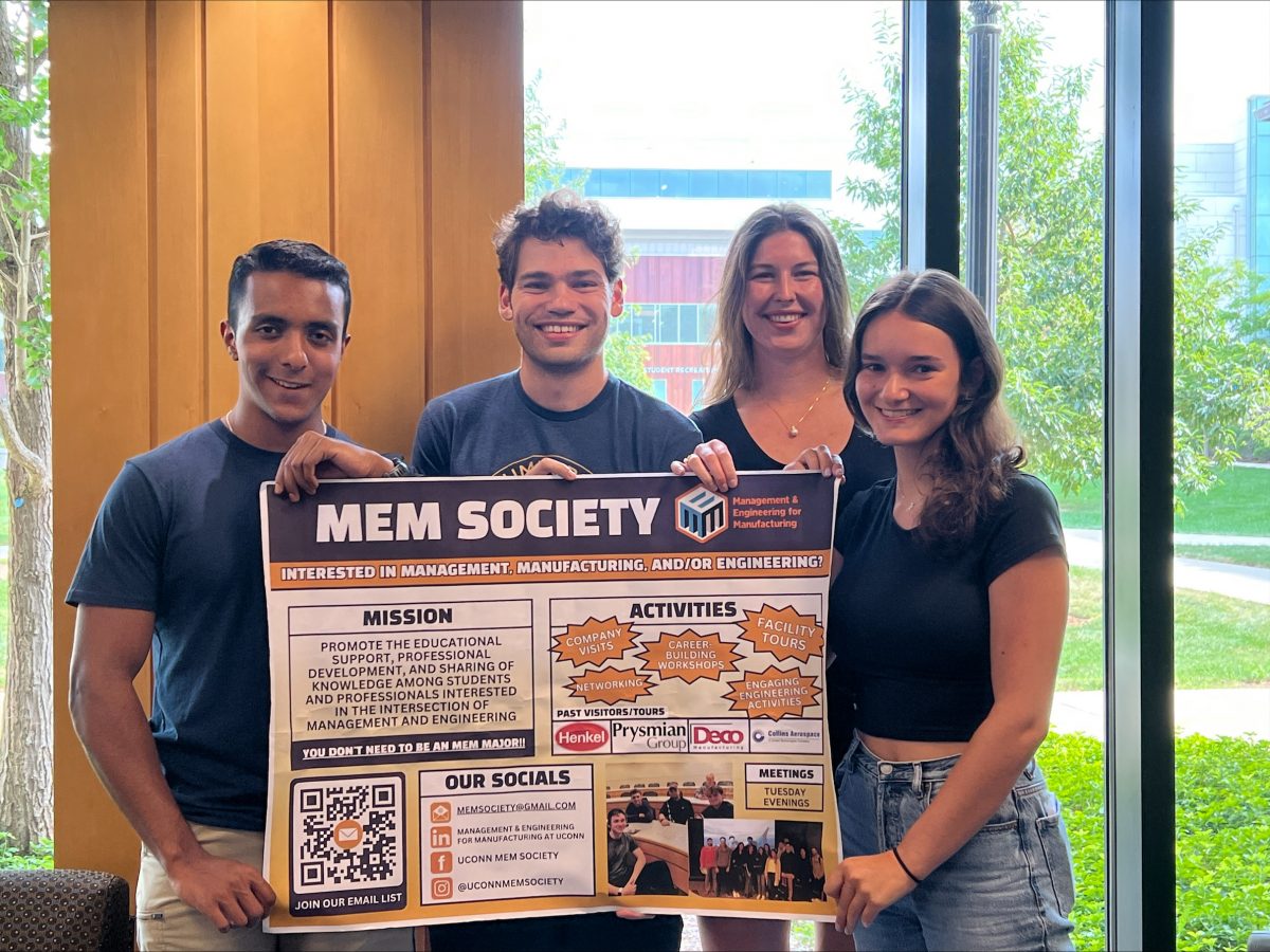 MEM Society's Executive Board holding a poster for the club.
